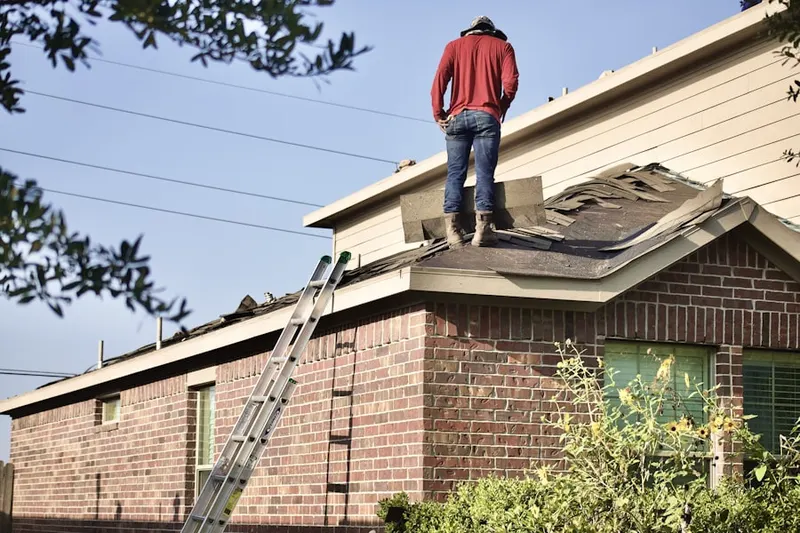 Professional roofer working on a residential roof in Anatolia Village